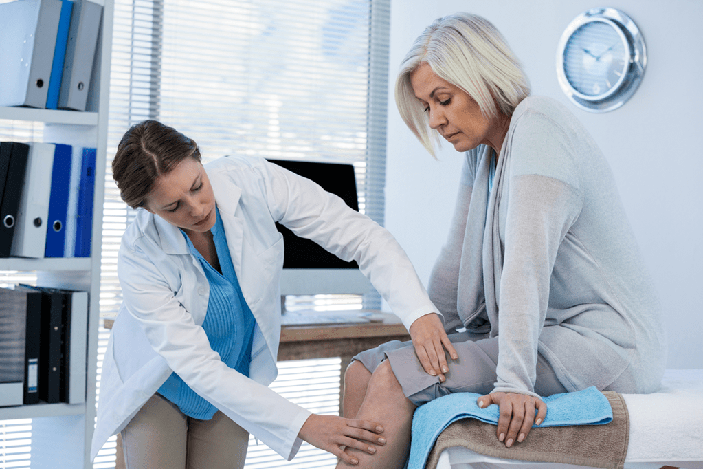 A patient suffering from arthrosis in need of medical attention being examined by a doctor